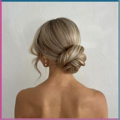 a woman with blonde hair in a low bun