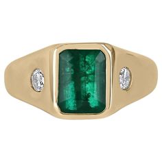 Displayed is a classic modern dark green emerald & round diamond three-stone men's unisex ring in 14K yellow gold. This unique solitaire ring carries an emerald in a secure hand bezel setting giving it extra protection and shine. Fully faceted, this very rare gemstone showcases very good shine, brilliance, and gem qualities. The emerald has very good clarity with minor flaws that are normal in all genuine emeralds! The gem has a deep medium-dark green color and a very good luster. Diamonds are b Gold Mens Ring, Emerald Ring Gold, Emerald Cut Rings, Gold Statement Ring, Ring Emerald, Heart Pendant Diamond, Birthstone Gifts, Mens Ring, Solid Gold Rings