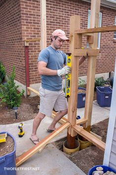 a man is working on a wooden structure