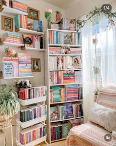 a room filled with lots of books on top of a book shelf next to a window