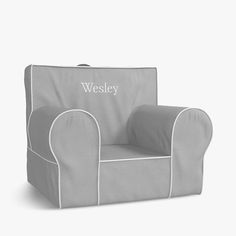 a gray chair with white trimming and the word, wesleyy written on it