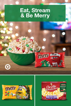 a green bowl filled with popcorn next to two bags of candy