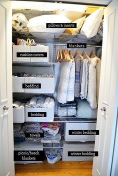 an organized closet with clothes, blankets and other items labeled in black text on the bottom shelf