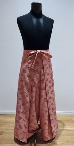 a mannequin with a pink skirt on it's back and bow at the waist