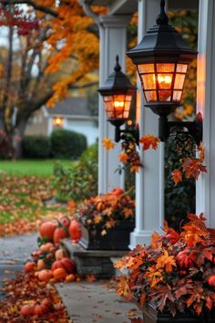 a couple of lights that are on the side of a building near some pumpkins