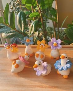 a group of rubber ducks sitting on top of a wooden table