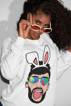 Everyone loves a BAD BUNNY Bad Bunny matching shirt and cup comb. Just in time for Spring! Sweatshirt only available in white.  Cup available in pink. Please allow 5-7 business days for processing.  Product Details 50% Preshrunk Soft Cotton, 50% Polyester Air jet yarn = softer feel and reduced pilling Double needle stitching at shoulder, armhole, neck, waistband and cuffs 1 x 1 rib with spandex Quarter-turned to eliminate center crease Garment Care Instructions - Do not iron directly on image. - Turn garment inside out and iron on low heat. - Do not use bleach . - Machine wash in cold water.  - Dry with low heat.  Shop Policy - No refunds, exchanges, or return after the item has been made. - Please make any changes before item is shipped.  Questions or concerns please contact shop owner di Bad Bunny Sweatshirt, Unisex Aesthetic, Bunny Sweatshirt, Spring Sweatshirt, Tumbler Set, Bad Bunny, Soapy Water, Matching Shirts, Cupping Set