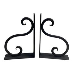 a pair of black metal bookends with swirly designs on each one side