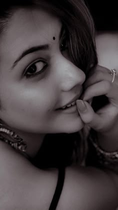 black and white photograph of a woman with piercings on her nose, looking at the camera