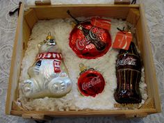 coca - cola christmas ornaments in a wooden box