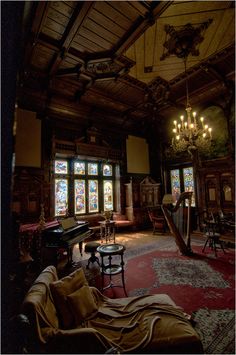 an ornate room with stained glass windows and chandelier