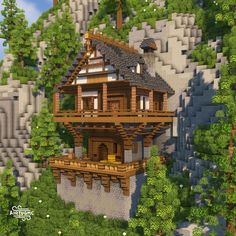 a house built into the side of a mountain with trees and rocks on it's sides