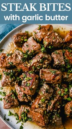 steak bites with garlic butter served on a white plate and garnished with parsley