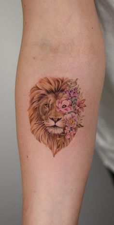 a tattoo with a lion and flowers on the side of her leg, next to an instagram page