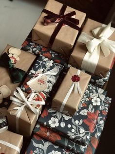 many wrapped presents are stacked on top of each other