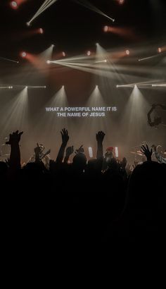 a group of people standing on top of a stage with their hands in the air