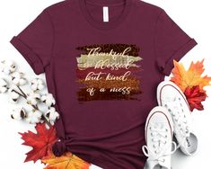 "\"Thankful and blessed but kind of a mess\" t-shirt This trendy fall shirt with autumn brush strokes is a perfect way to show your love of fall and all the colors of the fall season. This adorable fall shirt with a funny saying will be a great addition to your fall wardrobe. Wear this fall t-shirt with a pair of jeans, boots and a jacket or cardigan and you'll be stylin' for the season. CARE INSTRUCTIONS Design is professionally transferred using commercial grade equipment for a beautiful and d Inspirational Crew Neck T-shirt For Fall, Inspirational Graphic Print T-shirt For Fall, Inspirational Cotton T-shirt For Fall, Fall Custom Print Shirt With Relaxed Fit, Fall Season Relaxed Fit Shirt With Custom Print, Fall Relaxed Fit Shirt With Custom Print, Custom Print Shirt With Relaxed Fit For Fall, Relaxed Fit Shirt With Custom Print For Fall, Mom Thanksgiving Shirt