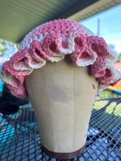 a crocheted hat is sitting on a mannequin's headdress