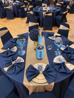 the table is set with blue linens and gold sequins for centerpieces