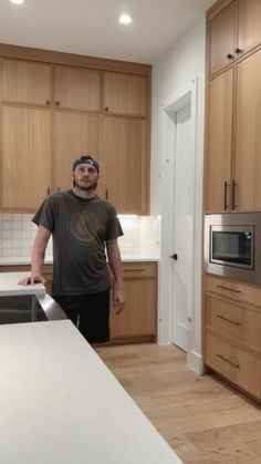 a man standing in the middle of a kitchen