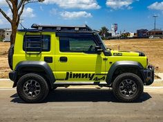 a bright yellow jeep is parked on the side of the road