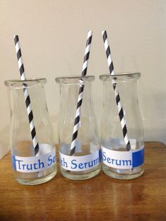 three glasses with black and white striped straws in them