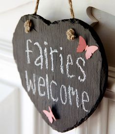 a heart shaped sign hanging from the side of a door