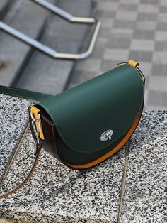 This leather bag, like all the others, uses our original ideas and handicrafts  Our quality is always higher than the price, see for yourself. Fashionable and stylish ladies rounded bag made of smooth Italian Mastrotto leather. Luxurious quality. Elegant and modern fashionable . Beautiful combination of colors - dark green, dark brown and mustard. Eco leather lining. Nickel-colored hardware. The set includes 2 leather straps, one 60 cm for carrying in the hand or at the bend of the elbow, the second 120 cm for carrying on the shoulder or over the shoulder. This model can be made of leather of different colors. With this bag you will be beautiful! Wonderful gift for girlfriend, sister, mother or yourself. 🎁 🔺Type: crossbody bag, shoulder bag, top handle bag 🔺Size: 22 * 18 * 8 cm (8,66x7,