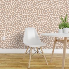 two white chairs sitting next to each other on top of a hard wood floor