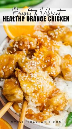 orange chicken is served with rice and garnished with sesame seeds