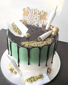 a birthday cake is decorated with chocolate and green icing