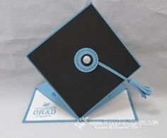 an origami graduation cap with tassels on the front and blue trim