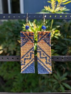 -Handmade native beaded rectangle wool earrings with fish hook earring backs. Leather backing the wool -Lapis Lazuli stone chip on top of wool strip -Shades of burnt orange, yellow and royal blue Pendleton® wool fabric -3.5 inches long, 1 inch wide -All pieces of jewelry are made with TLC by myself, Demiree! Brown Rectangular Bohemian Earrings, Bohemian Brown Rectangular Earrings, Native Print, Stone Chips, Pendleton Wool, Lapis Lazuli Stone, Fish Hook Earrings, Wool Fabric, Earring Backs