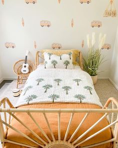 a bed room with a neatly made bed next to a plant and wallpaper on the walls