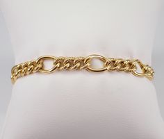 "Vintage Estate 14K Yellow Gold Link Bracelet. This bracelet weighs 7.5 grams, measures 7.5 mm in width and 7 1/4\" in length. This bracelet is traditionally called a textured Figaro Link but can be used for a charm bracelet.   I will ship this bracelet promptly in a gift box.  ADDITIONAL REQUESTS If you would like to see more pictures of this item, please let us know and we would be happy to provide them for you. Please contact us with all questions, we are here to help." Heirloom Yellow Gold Oval Link Bracelets, Heirloom Yellow Gold Oval Link Bracelet, Elegant Curb Chain Bangle, Heirloom Yellow Gold Chain Bracelet, Formal Heirloom Yellow Gold Chain Bracelet, Elegant Gold Tennis Bracelet With Curb Chain, Formal Heirloom Jubilee Chain Bracelet, Formal Oval Link Bracelet With Diamond Cut, Formal Oval Figaro Chain Jewelry