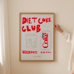 a woman standing in front of a poster with the words diet coke club on it