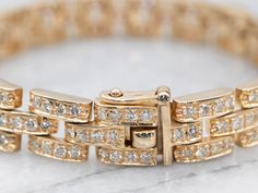 Stunning! This diamond bracelet is bold yet elegant. The curb chain links of the bracelet create a lovely geometric design, while the high-quality diamonds keep the look modern and fresh, adding a tone of sparkle to the sleek polished yellow gold.Metal: 14K Yellow GoldGem: 202 Diamonds totaling 5.05 Carats, SI in Clarity, H in ColorGem Measurements: 1.8 mm, RoundWidth: 9.3 mmLength: 7 InchesMarks: “14K” Stamped on the clasp Anniversary Diamond Bracelet With Solid Link Construction, Formal Link Diamond Bracelet With Accents, Formal Link Gold Bracelet With Diamond Accents, Formal Gold Link Bracelet With Diamond Accents, Formal Diamond Chain Link Bracelet, Yellow Gold Chain Link Diamond Bracelet For Formal Occasions, Formal Yellow Gold Diamond Chain Link Bracelet, Formal Yellow Gold Chain Link Diamond Bracelet, Classic Diamond Bracelet With Chain Link For Formal Occasions