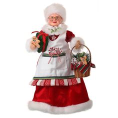 a santa clause doll holding a basket with candy canes