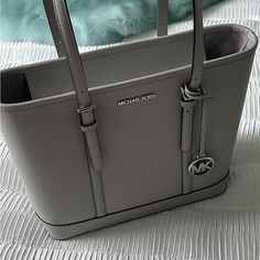 Brand New Michael Kors Jet Set Travel Small Grey Shoulder Tote Handbag! Never Worn, It Features Adjustable Shoulder Straps, Inner Zip And Slip Pockets, Mk Bag Charm And Jacquard Lining Tote Bag Saffiano Leather 100% Leather From Tanneries Meeting The Highest Standards Of Environmental Performance Gold-Tone Hardware 17”W X 11.5”H X 6.25”D Handle Drop: 11” Interior Details: Back Zip Pocket, 2 Front Slip Pockets Lining: 100% Polyester Zip Fastening Dust Bag Not Included Imported Style # 35f0gtvt9l Michael Kors Saffiano Leather Office Bag, Everyday Michael Kors Saffiano Leather Bag, Saffiano Leather Bag With Silver-tone Hardware For Shopping, Michael Kors Soft Leather Bags For Office, Michael Kors Saffiano Leather Shoulder Bag For Shopping, Michael Kors Saffiano Leather Everyday Shoulder Bag, Michael Kors Saffiano Leather Shoulder Bag, Modern Michael Kors Saffiano Leather Bag, Mk Bags