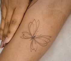 a woman's foot with a flower tattoo on it