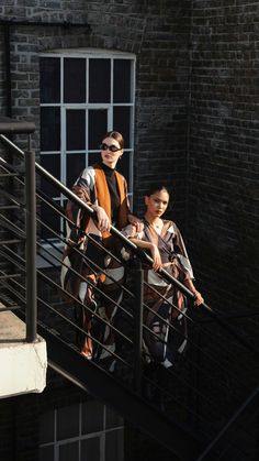 two people walking up some stairs together