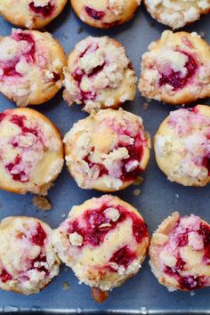 freshly baked raspberry muffins on a baking sheet ready to be eaten