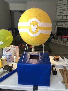 a yellow and white ball sitting on top of a blue box next to other items