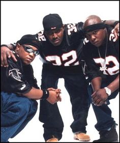 three young men in black jerseys posing for a photo