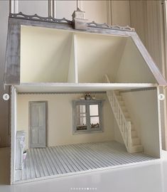 a doll house with stairs leading up to the second floor and another room on the third floor