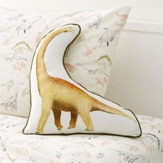 a pillow with an image of a dinosaur on it