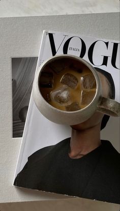 a magazine with a man's head covered in ice cubes on top of it