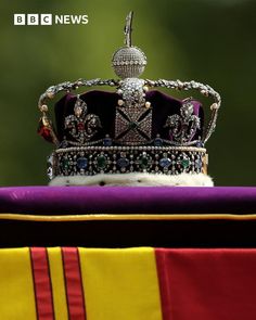 a crown sitting on top of a purple and yellow blanket