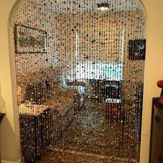 an open door with lots of bottle caps all over the front and back doors,