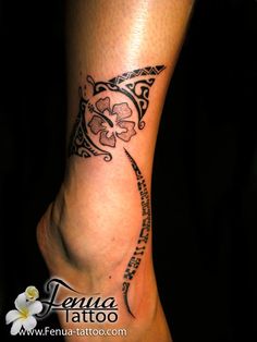 a woman's foot with a flower tattoo on the side of her leg and an arrow